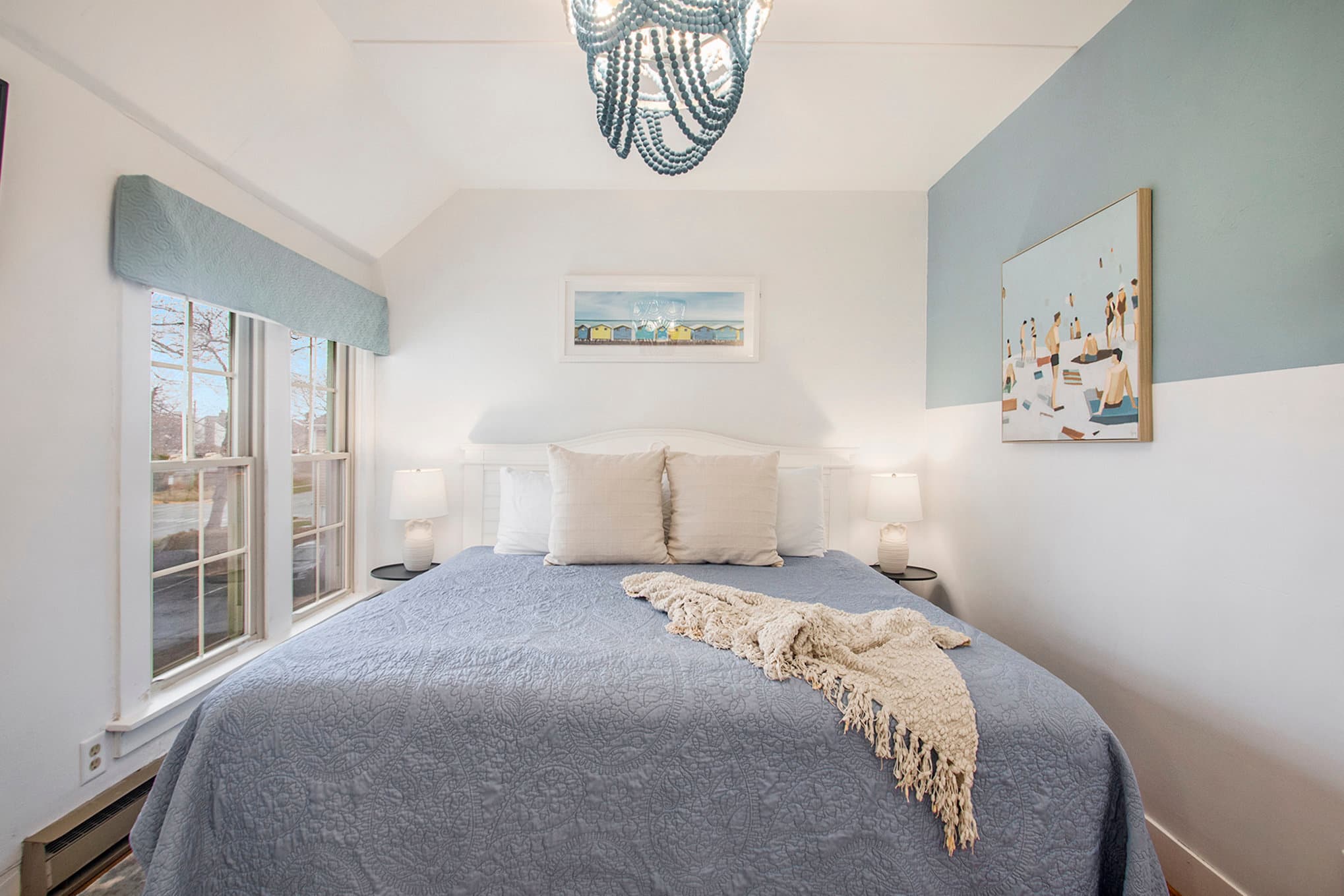 King bed with blue wall, side tables and lamps