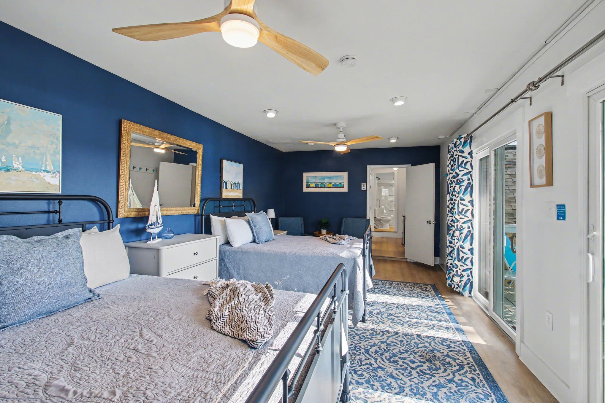 two queen beds and view of balcony