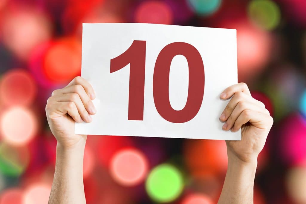 two hands holding a sign that says 10